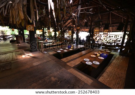 PAKXAY - LAO PDR - JANUARY 21 : Landscape with vintage restaurant built with old teak from big teak tree at Phar Sorm forest waterfall on Jan 21, 2015 in Pakxay district, Lao PDR