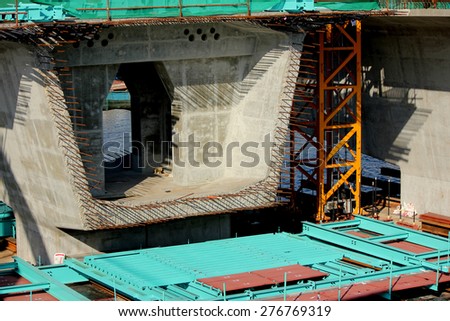 Concrete bridge across Chaophraya river under-construction of its foundation and road surface supporting structure.