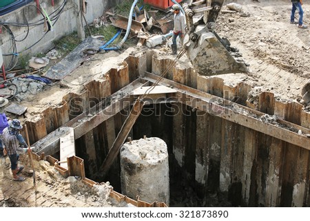 AUGUST 30, 2015 ; NONTHABURI - THAILAND : Piling work of concrete foundation under-construction and cutting of piles tip.
