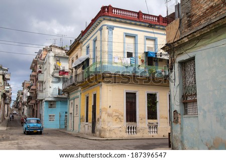 Havana, Cuba - Novemder, 09, 2011: Cuban street, vintage car and people hurrying about their business