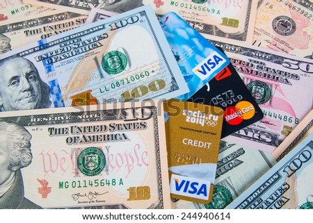 KIROV, RUSSIA - JANUARY 18, 2015: Photo of VISA and Mastercard credit card with USA dollars bills