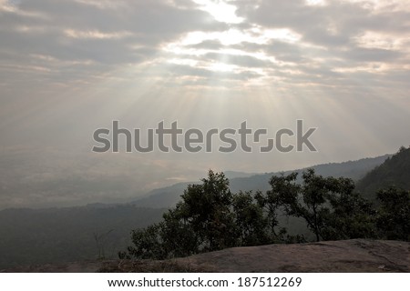 A ray of sunlight breaking through dark clouds.(PhuKradueng National Park), Thailand
