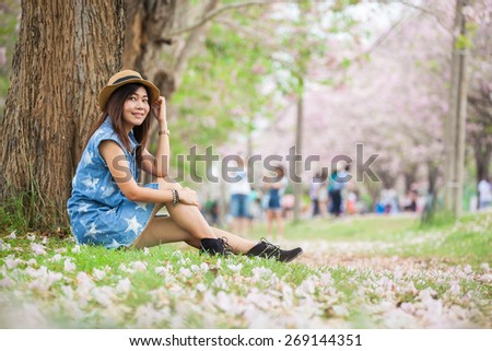 Young woman traveller with Tabebuia heterophylla (Pink Trumpet Tree )