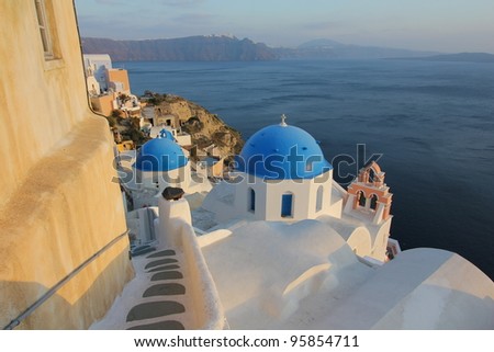 Stairs going down to Church Dome and Bell in Santorini at sunset