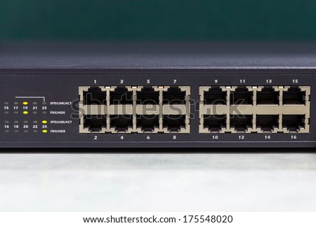 part of Network switch with 16 ports on the office table, Front view version