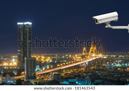 Security camera monitoring The Bhumibol Bridge with cityscape at twilight, bangkok, thailand