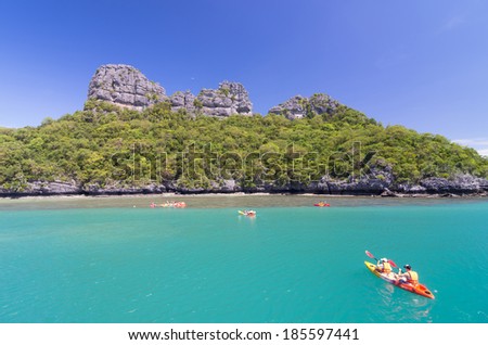 KOH SAMUI, THAILAND - JUNE 29 : two undefined traveler are padding a kayak to the traveler group in front of the island on June 29, 2013.