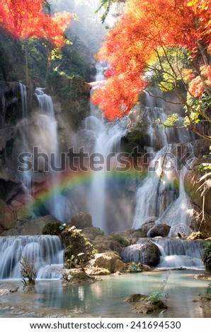 Beautiful waterfall with soft focus and rainbow in the forest