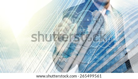 Double exposure of businessman writing the idea with cityscape building glass