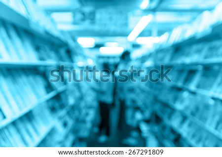 Abstract blurred photo of book store with people background, blur color tone
