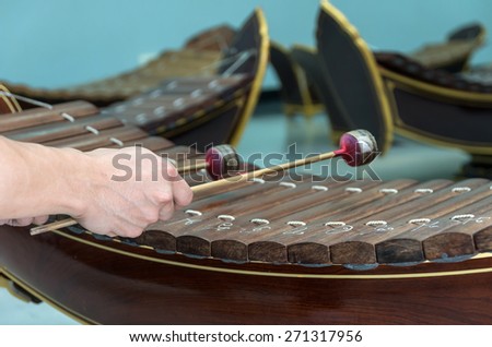 Hand hitting the Thai musical instrument (xylophone),asian instrument, focus on hand
