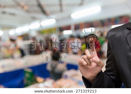 Abstract blurred photo of book store with Businessman pointing the idea on people background