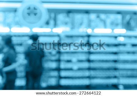 Abstract blurred photo of book store with people background, blue color tone