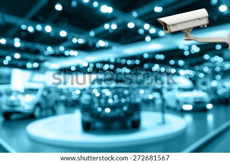 CCTV security camera on monitor the Abstract blurred photo of motor show, car show room, blur color tone