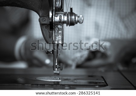 The vintage sewing machine on fashion designer blur background, black and white tone