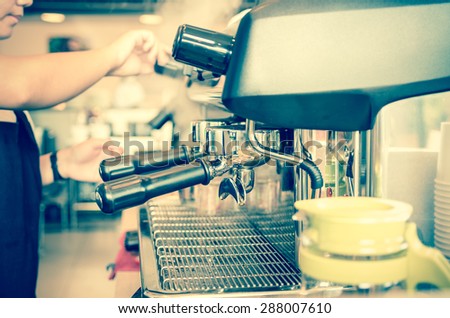 Coffee machine making espresso shot by barista in a cafe shop