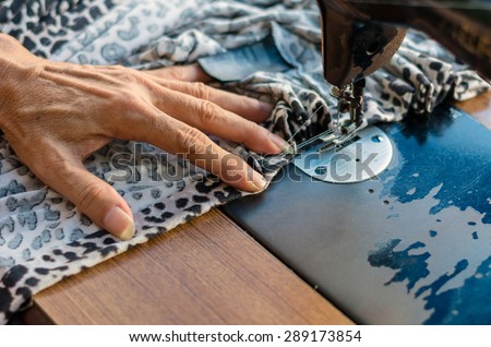 Closeup Sewing Process with old man designer hand, focus at finger
