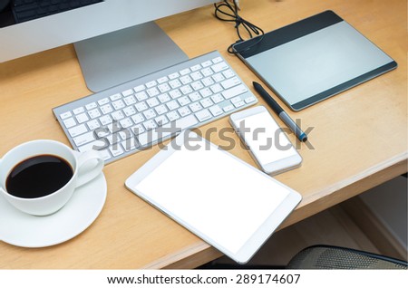 Workplace, computer, tablet, smart phone and key board on wooden table