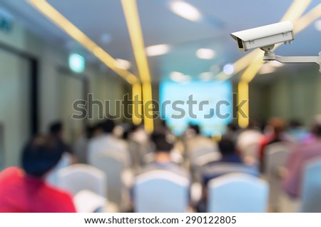 CCTV security camera on monitor the Abstract blurred photo of conference hall or seminar room with attendee background