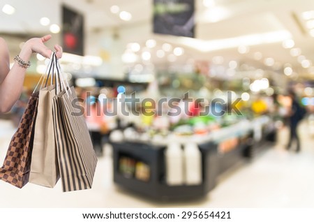 Holding shopping bags by hand on salad bar store blur with bokeh background, Miscellaneous Product shelf