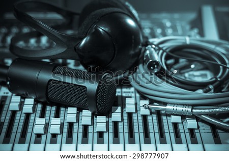 Close up of microphone with headphone on mixer, music instrument concept