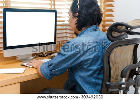 Grapphic designer working at Workplace with computer, tablet, smart phone and key board on wooden table