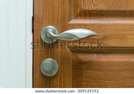Door handle in Modern style on wooden door