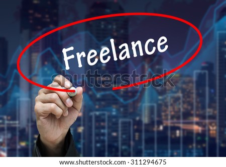 Man Hand writing Freelance by black marker on visual screen. Business concept