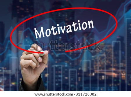 Man Hand writing Motivation by black marker on visual screen. Business concept