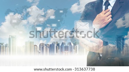 Double exposure of businessman using the tablet for sending the email on world map and cityscape background, business concept,Elements of this image furnished by NASA