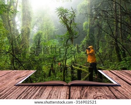 conceptual book image of Traveller taking photo at Beautiful rain forest
