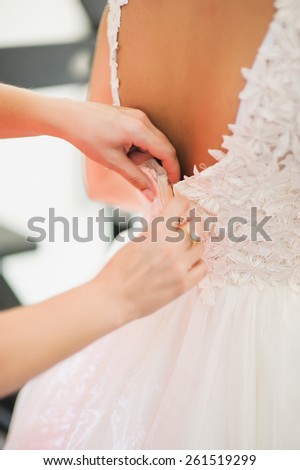bride getting dressed on her best day ever