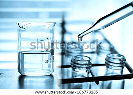 Laboratory Research, dropping chemical liquid to test tube with beaker
