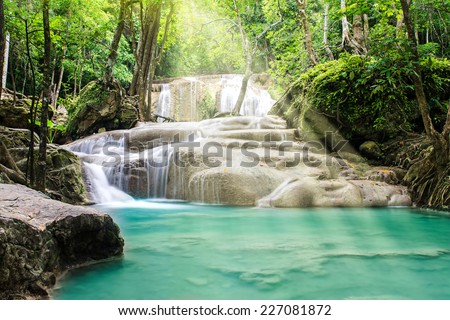 Erawan waterfall with sunshine in tropical forest, Thailand