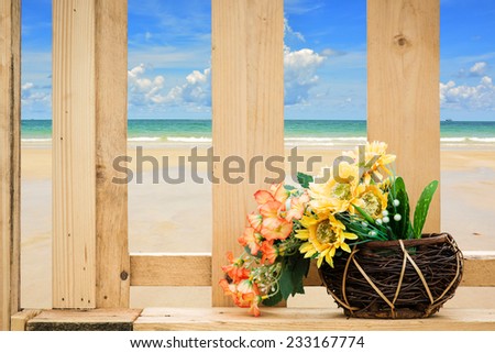 Flower bouquet on wooden fence with sea beach background