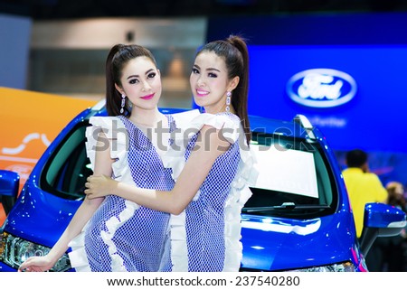 BANGKOK - DECEMBER 4 : Unidentified model with Ford car on display at The 31st Bangkok International Motor Expo on DECEMBER 4, 2014 in Bangkok, Thailand.