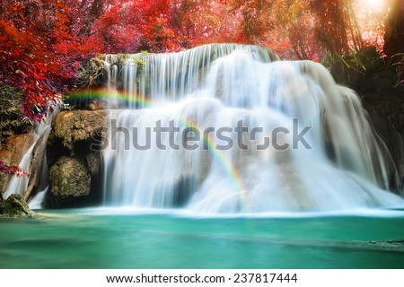 Huay Mae Khamin waterfall with rainbow in tropical forest of national park, Thailand