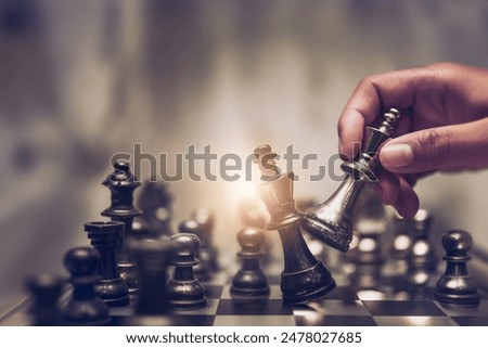 Similar – Image, Stock Photo Player moves a chess piece on a chessboard