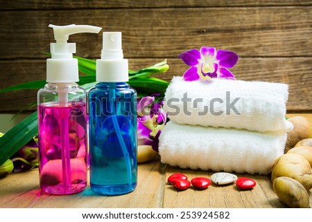 Essential body massage oils in a bottles with violet orchid for body treatment
