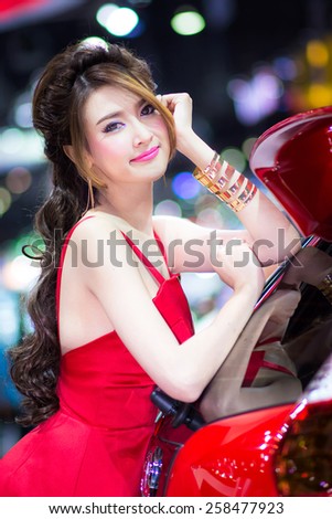 BANGKOK - DECEMBER 6, 2014 : Unidentified model with MG on display at The 31st Bangkok International Motor Expo on DECEMBER 6, 2014 in Bangkok, Thailand.