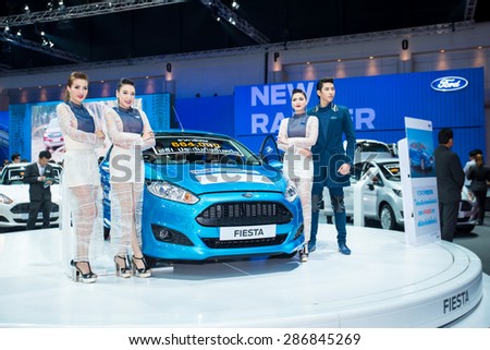 BANGKOK - April 5, 2015 : Unidentified model with Ford car on display at The 36th Bangkok International Motor show on April 5, 2015 in Bangkok, Thailand.