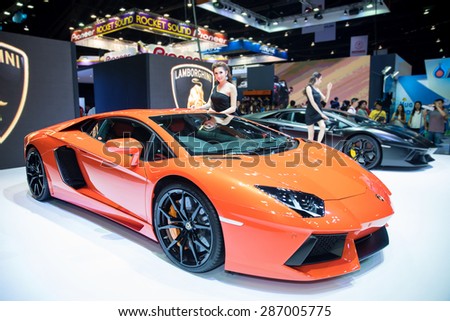 BANGKOK - April 5, 2015 : Unidentified model with Lamborghini super car on display at The 36th Bangkok International Motor show on April 5, 2015 in Bangkok, Thailand.