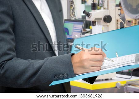 Business woman inspect a document with blur lab equipment background