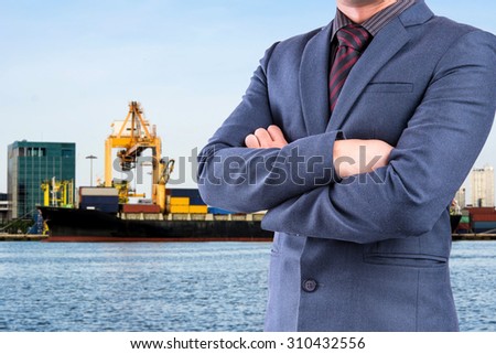 Business man in suit on blur ship at sea port background