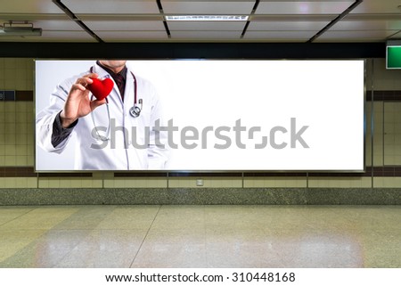 doctor holding red heart on billboard with white space