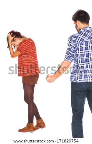 Domestic violence as a social problem - Angry husband is holding his fist up next to his young frightened wife - isolated on white