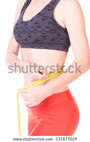 Woman\'s  waist measure  holding a yellow centimeter in hands - isolated on white,