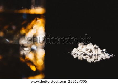 Alcohol and cocaine on a black background