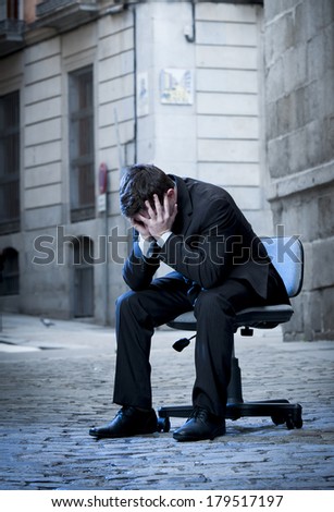 frustrated Business Man sitting on Office Chair on Street in stress and crying