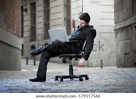 Exhausted Business Man sitting on Office Chair on Street sleeping